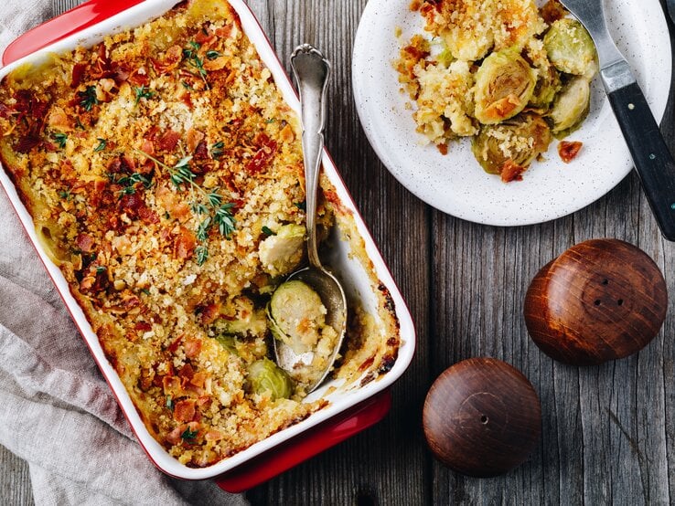 Draufsicht auf eine rechteckige Auflaufform gefüllt mit einem kross überbackenem Rosenkohlauflauf.  | © iStock.com/wmaster890