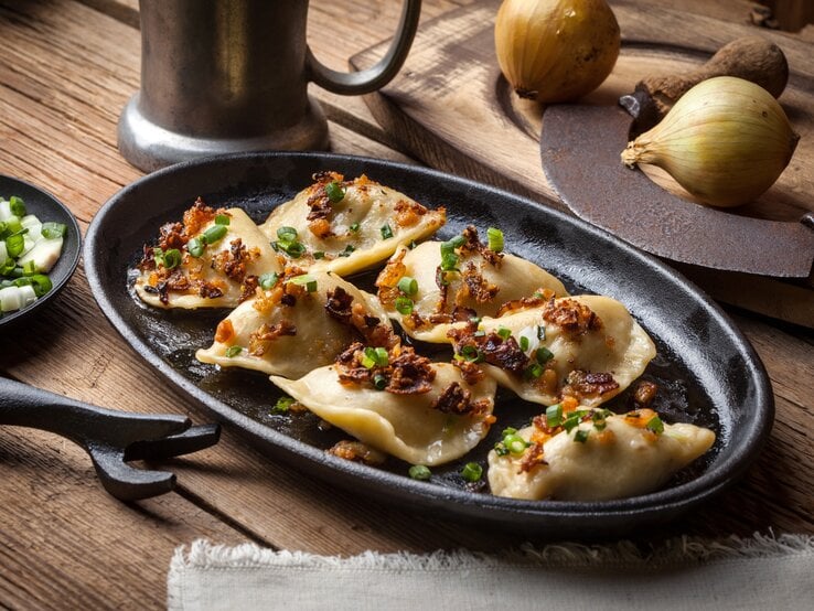Mehrere Pierogi auf einem teller.  | © iStock/arfo