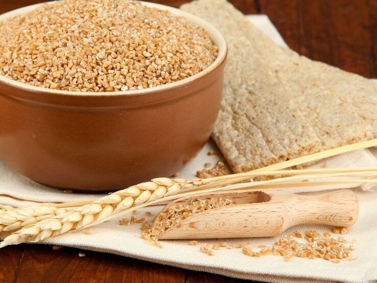 Schüssel mit Bulgur, Knäckebrot und Weizenähren als Dekoration. | © pixelshot via Canva.com