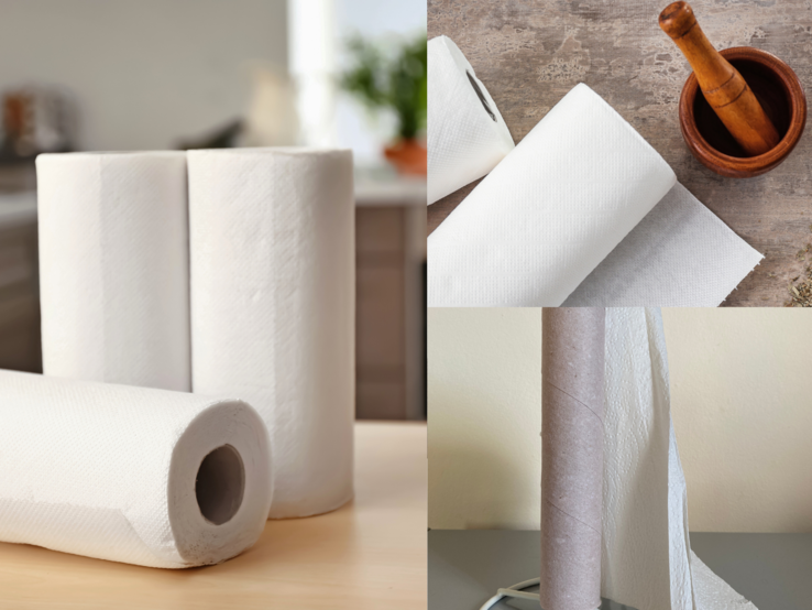 Vier weiße Küchenrollen in verschiedenen Zuständen liegen auf Tischen in Küche und Essbereich, eine ist fast aufgebraucht.