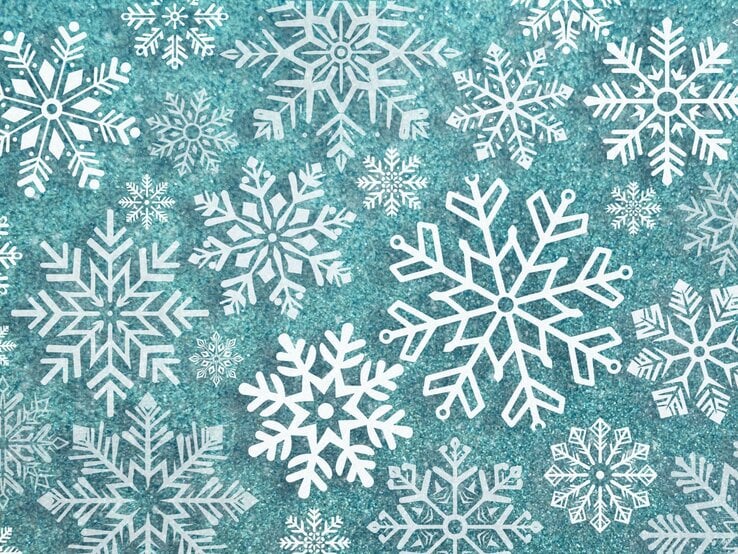 Weiße DIY-Schneeflocken auf türkisem Hintergrund